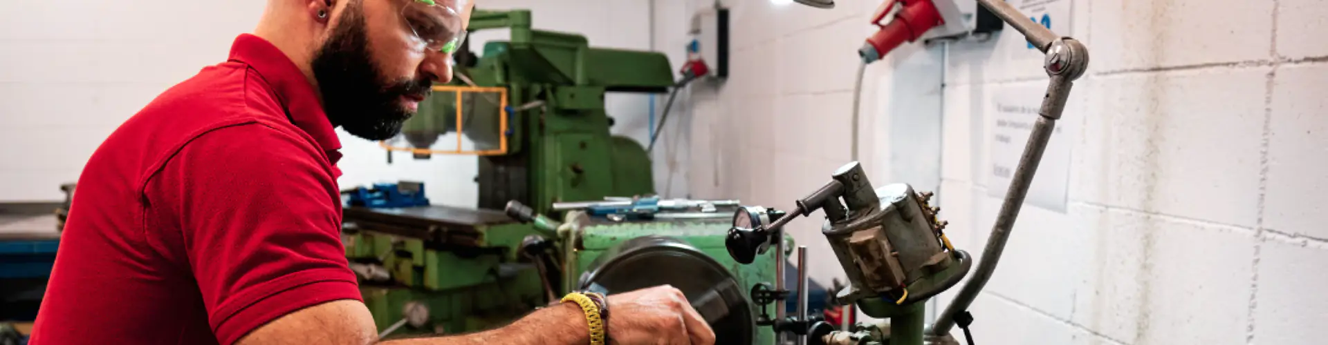 Homme travaillant sur un tour sans sécurité de la machine.
